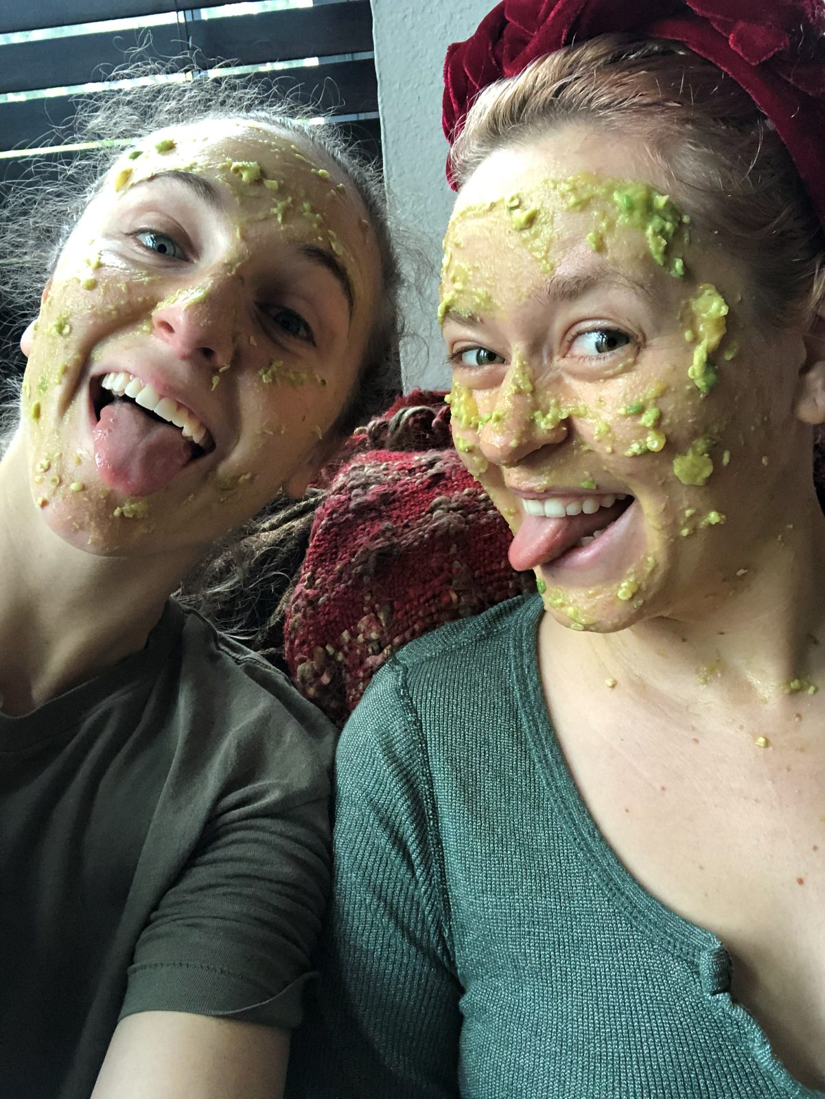 Hope and a friend sticking their tongues out in homemade avocado face masks